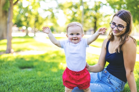 Mom with daughter in grass