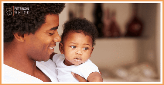 Father holding infant son