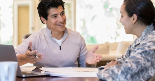Man talking to woman in uniform about document